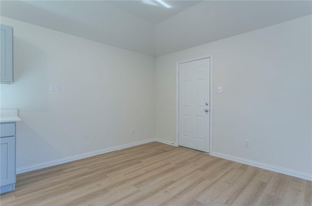 empty room featuring light wood-style flooring and baseboards