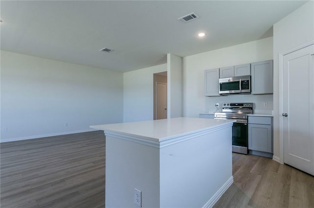 kitchen with stainless steel appliances, light countertops, visible vents, and gray cabinetry