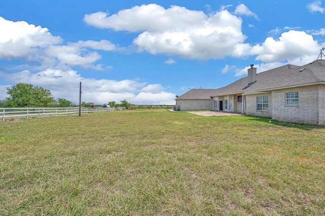 view of yard with a patio area and a rural view