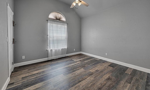 empty room featuring vaulted ceiling, ceiling fan, baseboards, and wood finished floors