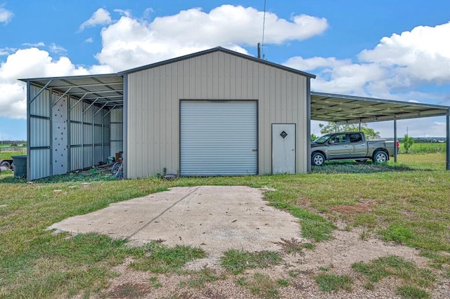 garage with a carport and a yard