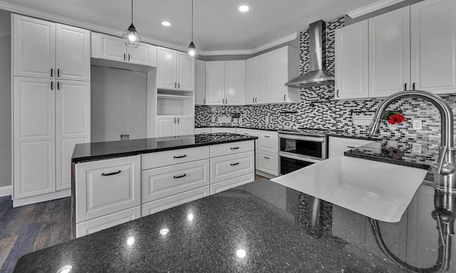 kitchen with dark wood-style flooring, backsplash, white cabinets, wall chimney range hood, and dark stone counters