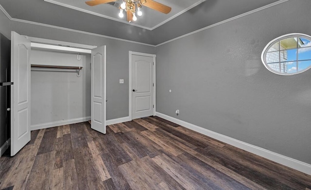 unfurnished bedroom featuring crown molding, ceiling fan, and dark wood-type flooring