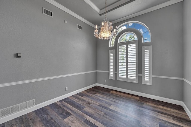 empty room featuring dark wood-style floors, ornamental molding, visible vents, and baseboards