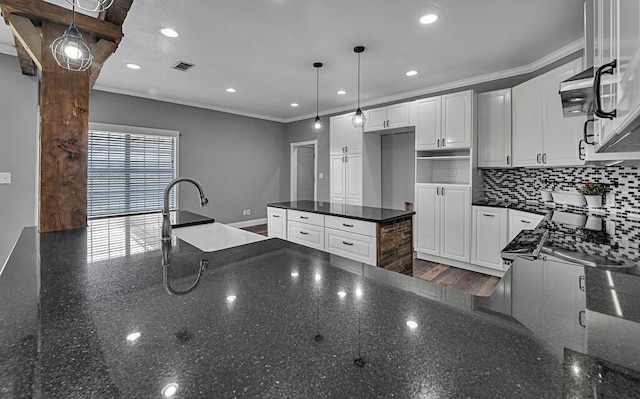 kitchen with crown molding, visible vents, decorative backsplash, white cabinets, and dark stone counters