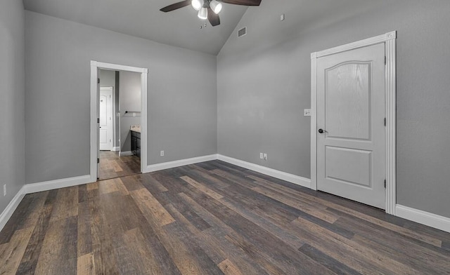 unfurnished bedroom featuring dark wood-type flooring, ensuite bath, ceiling fan, and lofted ceiling