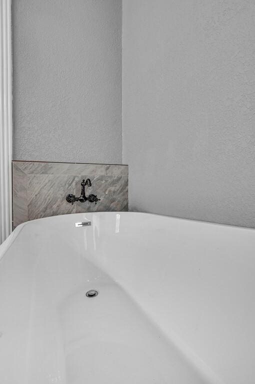 room details with a textured wall and a soaking tub