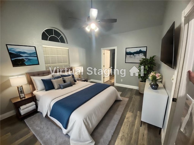 bedroom featuring dark wood-style floors, a ceiling fan, and baseboards