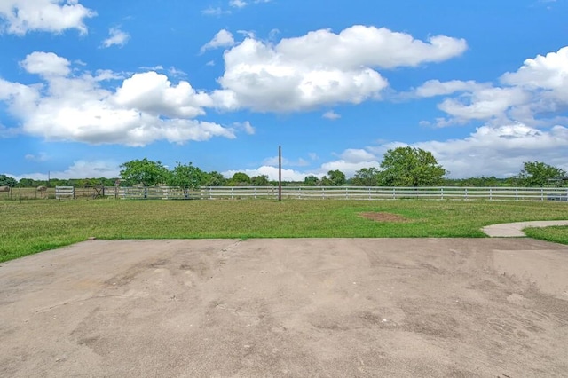 view of yard featuring a rural view and fence