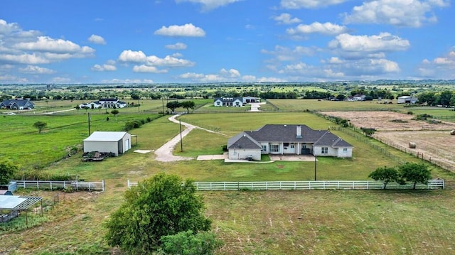 birds eye view of property with a rural view