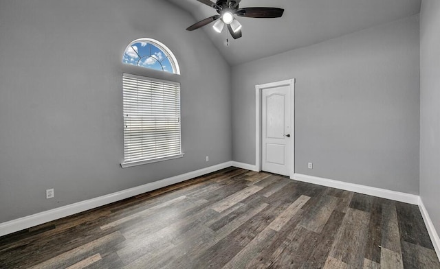 spare room featuring dark hardwood / wood-style floors, ceiling fan, and high vaulted ceiling