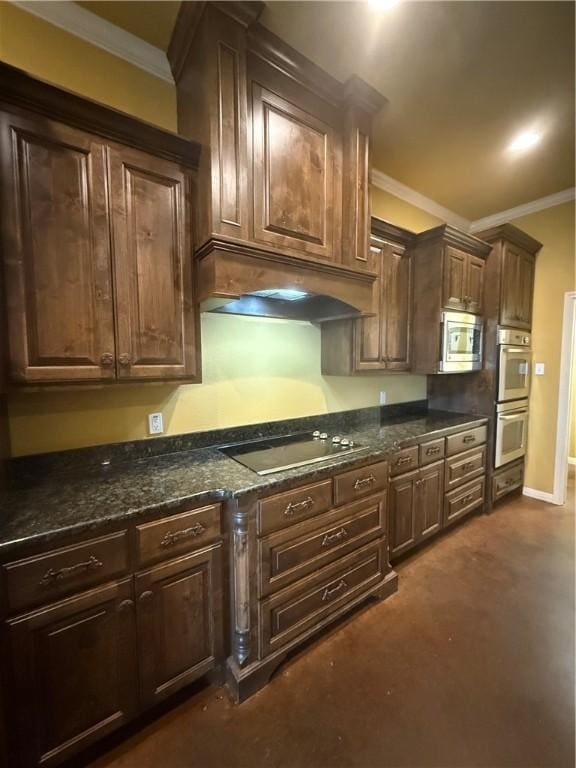 kitchen with under cabinet range hood, appliances with stainless steel finishes, dark brown cabinets, and ornamental molding