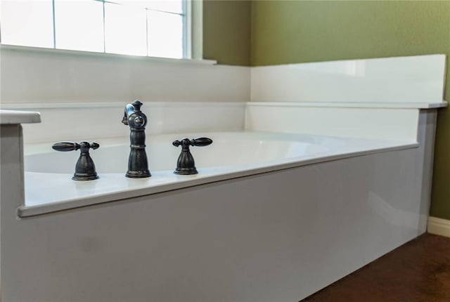 bathroom with a garden tub