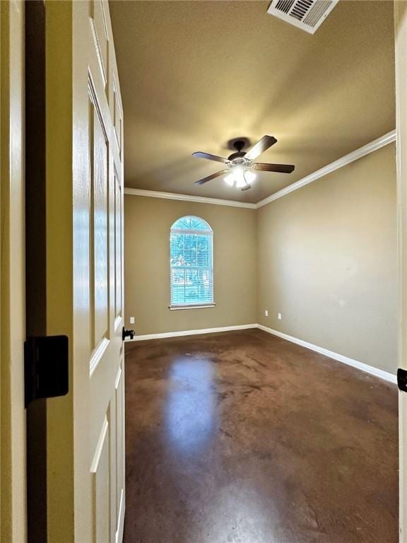 spare room with finished concrete flooring, baseboards, visible vents, ceiling fan, and ornamental molding