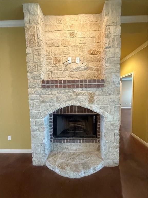 room details featuring crown molding, a fireplace, and baseboards