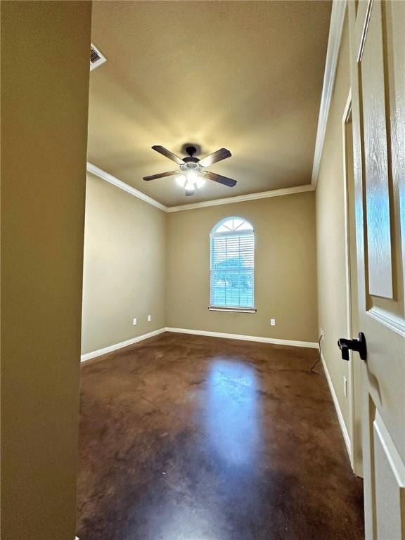 empty room with crown molding, concrete floors, and baseboards