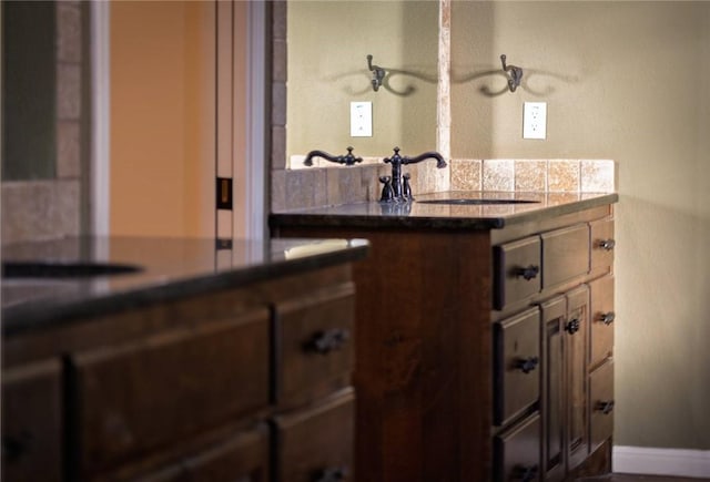 bathroom with baseboards and a sink