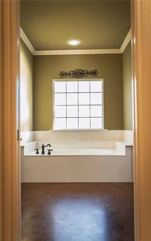 bathroom with a bath, finished concrete floors, and crown molding