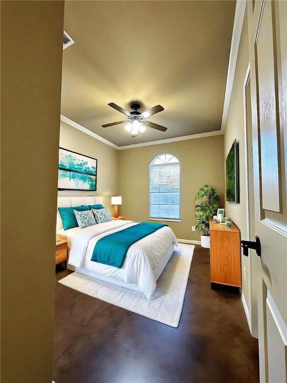 bedroom featuring finished concrete flooring, a ceiling fan, baseboards, and crown molding