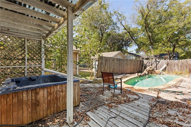 wooden deck featuring a pool with hot tub