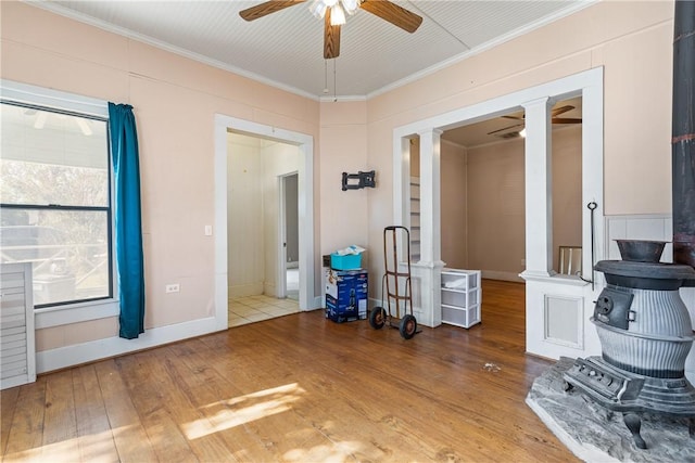 interior space with hardwood / wood-style floors, ceiling fan, and crown molding