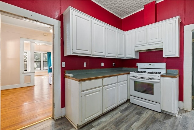 kitchen featuring dark hardwood / wood-style floors, white cabinetry, and white range with gas stovetop