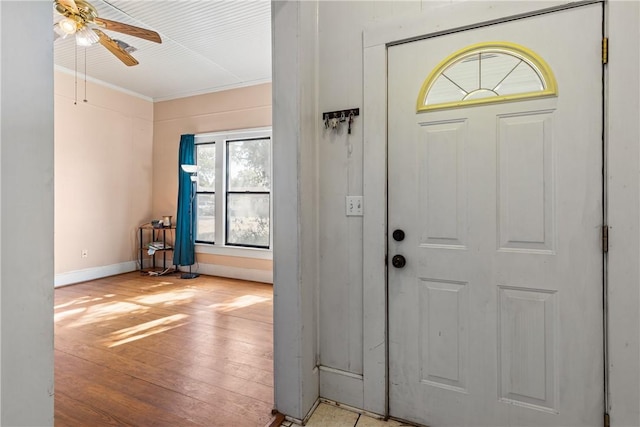 foyer featuring light hardwood / wood-style flooring, ceiling fan, and ornamental molding