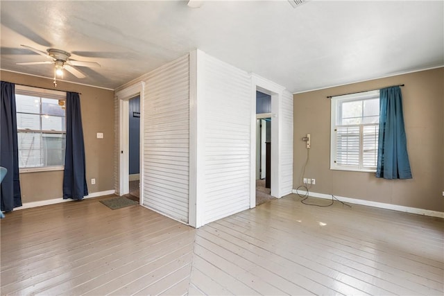 spare room with hardwood / wood-style floors, ceiling fan, and crown molding