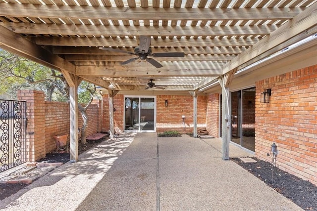 view of patio with ceiling fan, a pergola, and fence