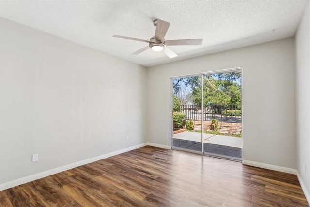 unfurnished room with a textured ceiling, a ceiling fan, baseboards, and wood finished floors