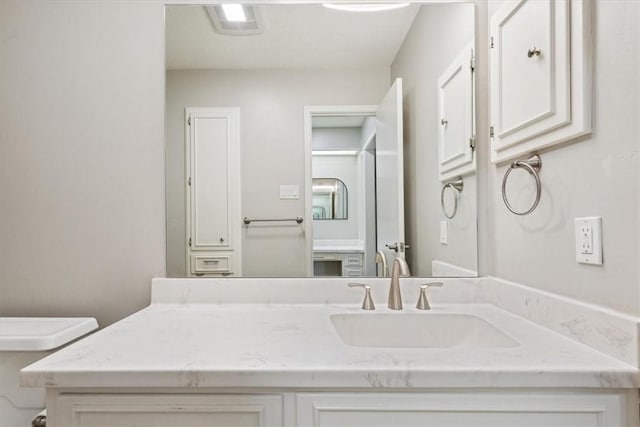 bathroom featuring toilet and vanity