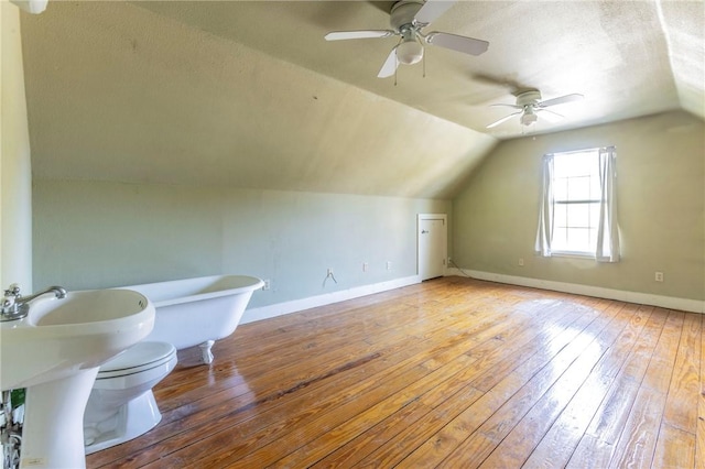 bonus room featuring hardwood / wood-style flooring, ceiling fan, and lofted ceiling