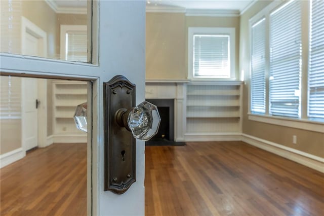 interior details featuring crown molding and hardwood / wood-style floors