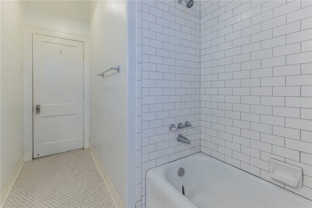 bathroom with tile patterned flooring and tiled shower / bath