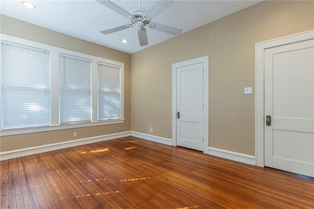 spare room with ceiling fan and dark wood-type flooring