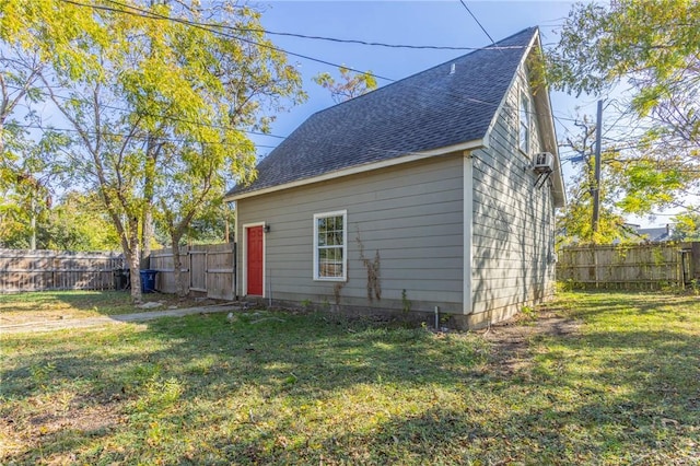 rear view of property featuring a lawn