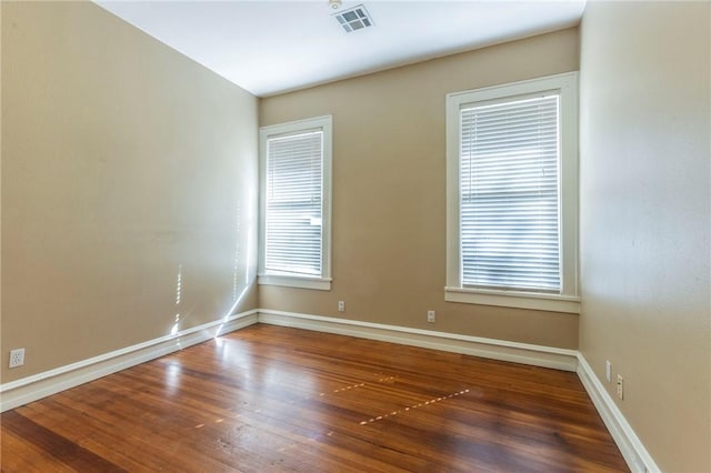 spare room with dark wood-type flooring