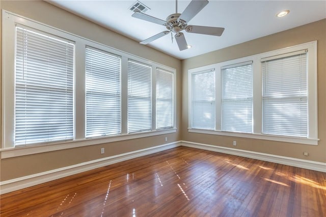 unfurnished sunroom with ceiling fan