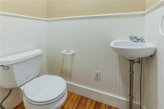 bathroom with wood-type flooring and toilet