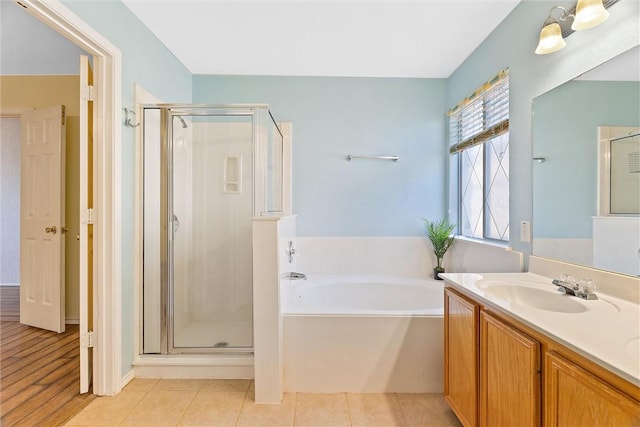 bathroom featuring shower with separate bathtub, vanity, and hardwood / wood-style flooring