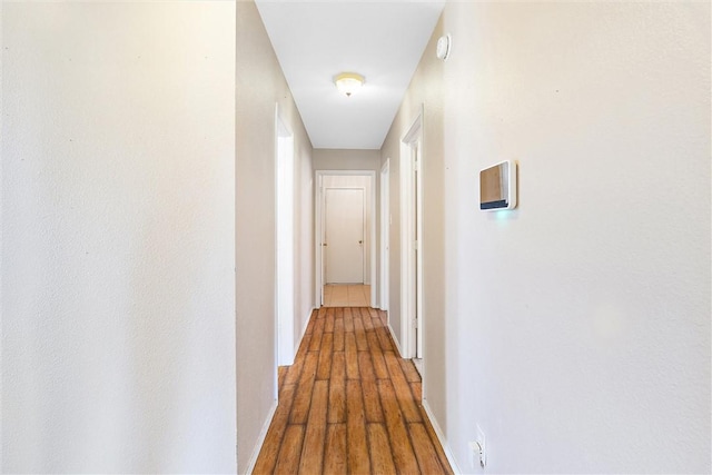 hall with wood-type flooring