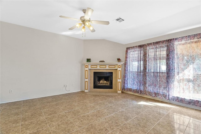 unfurnished living room with a tiled fireplace, ceiling fan, and light tile patterned floors