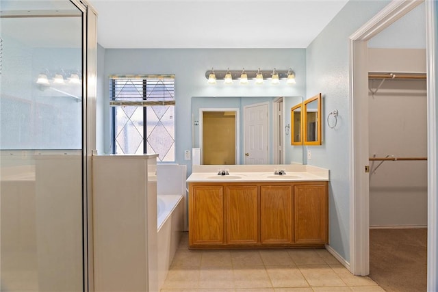 bathroom featuring tile patterned floors, a bathing tub, and vanity