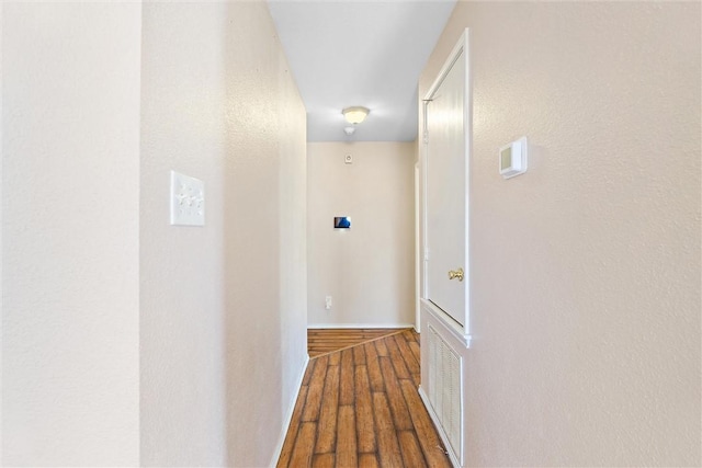 corridor with hardwood / wood-style floors