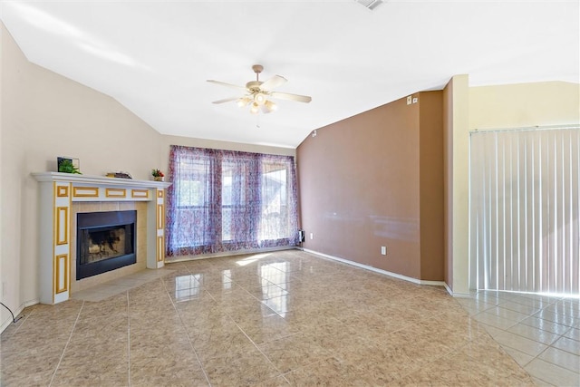 unfurnished living room featuring ceiling fan, light tile patterned flooring, lofted ceiling, and a tiled fireplace