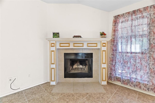 interior details featuring a tile fireplace