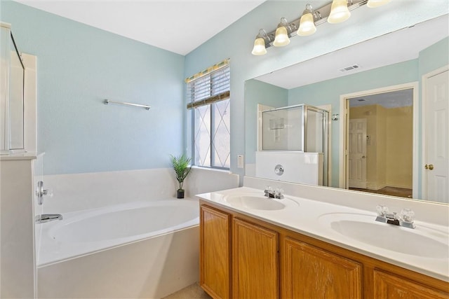 bathroom with shower with separate bathtub and vanity