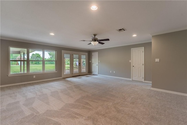 carpeted empty room featuring ceiling fan and ornamental molding