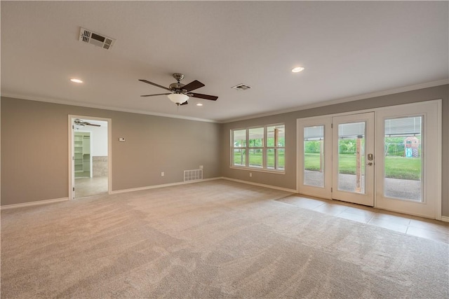 carpeted spare room featuring ceiling fan and ornamental molding