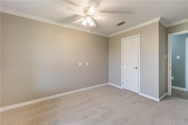 unfurnished bedroom with a closet, light colored carpet, ceiling fan, and crown molding